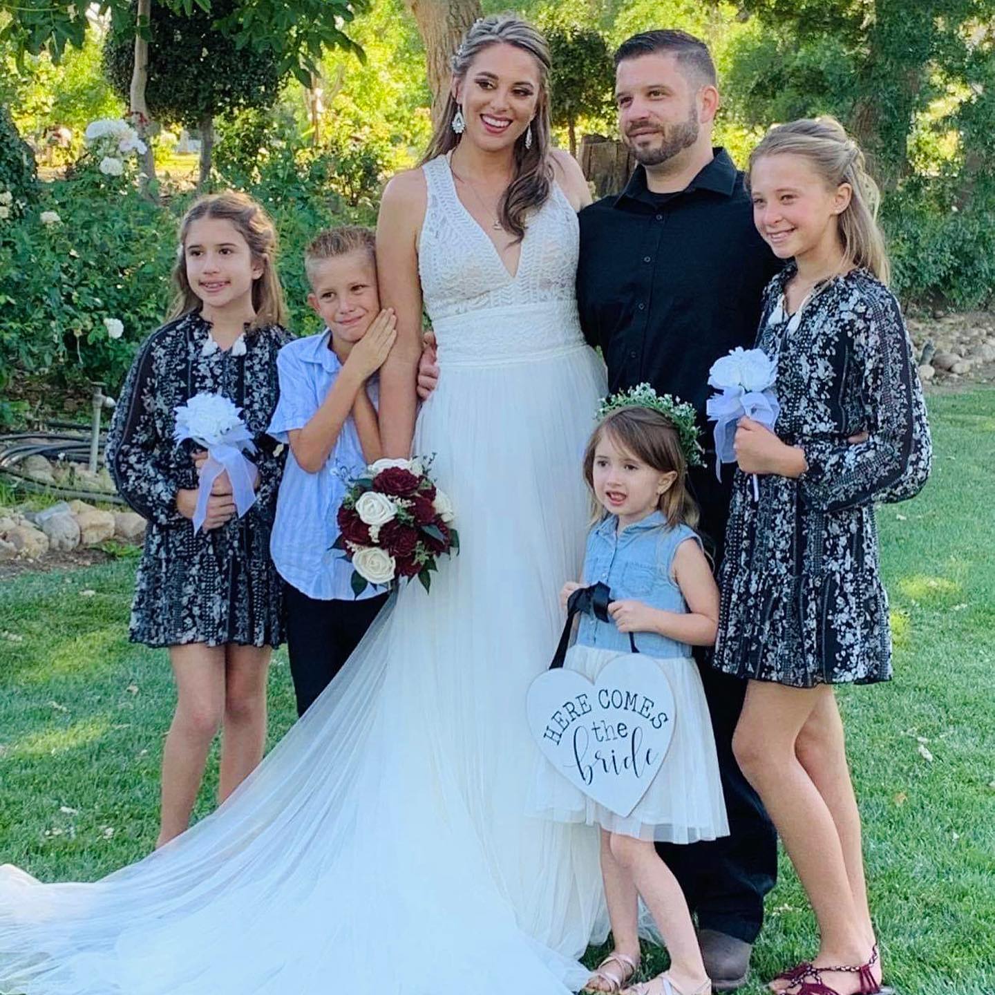 Blonde bride in white wedding dress and Groom with Flower Girls